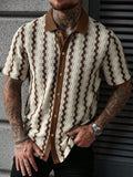 Man wearing a cream and brown short sleeve knit shirt with a patterned design and brown collar, hand in pocket.