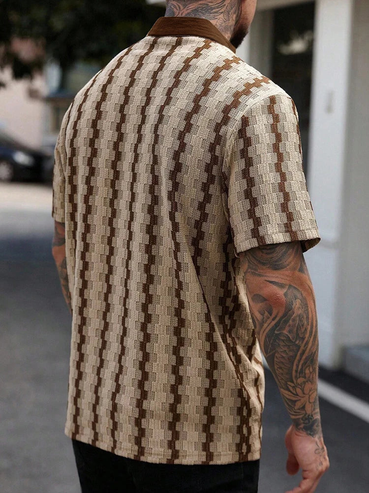 Man wearing a cream and brown patterned knit short sleeve shirt with a solid brown collar, viewed from the back.