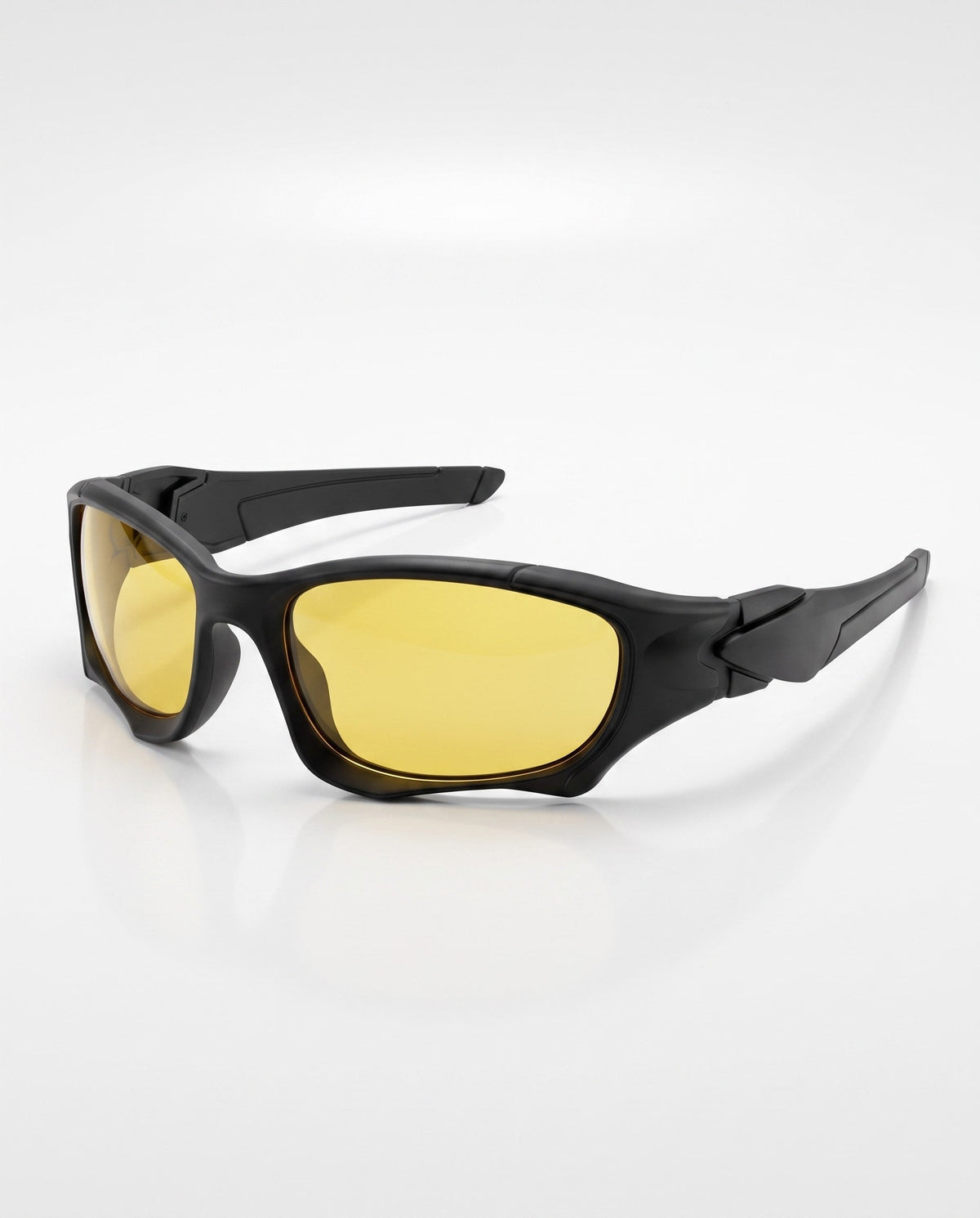 Matte black sports sunglasses with bright yellow tinted lenses, angled on a white reflective surface.
