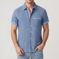 Blue shirt on an off-gray studio background