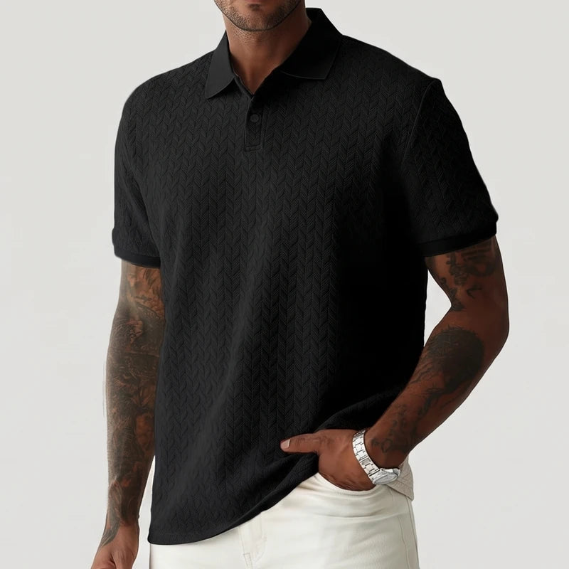 Black polo on an off-gray studio background