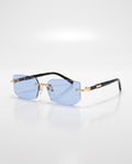 Light blue rimless sunglasses featuring rectangular lenses, gold-toned hardware, and black arms with a small golden detail.