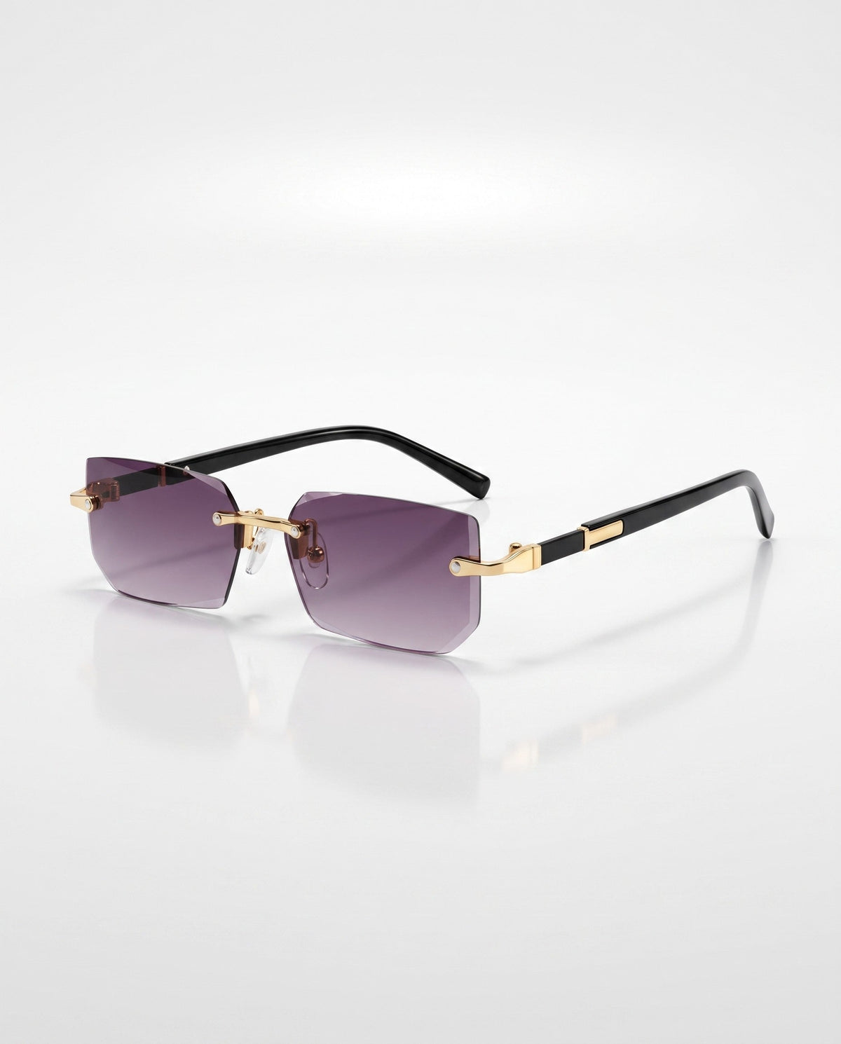 Rimless sunglasses with faceted purple gradient lenses, gold bridge, and black temples featuring gold accents, on a white background.