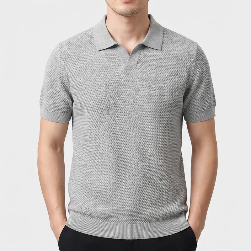Gray knitted polo on an off-gray studio background