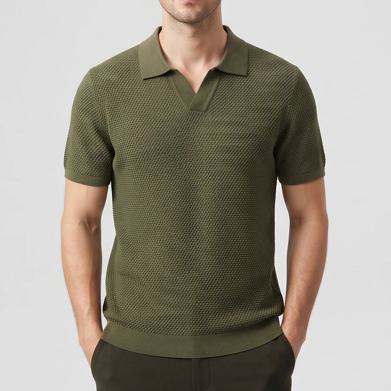Green knitted polo on an off-gray studio background