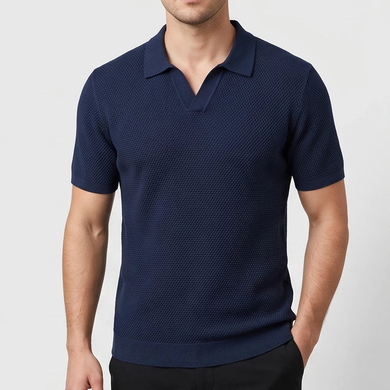 Navy Blue knitted polo on an off-gray studio background
