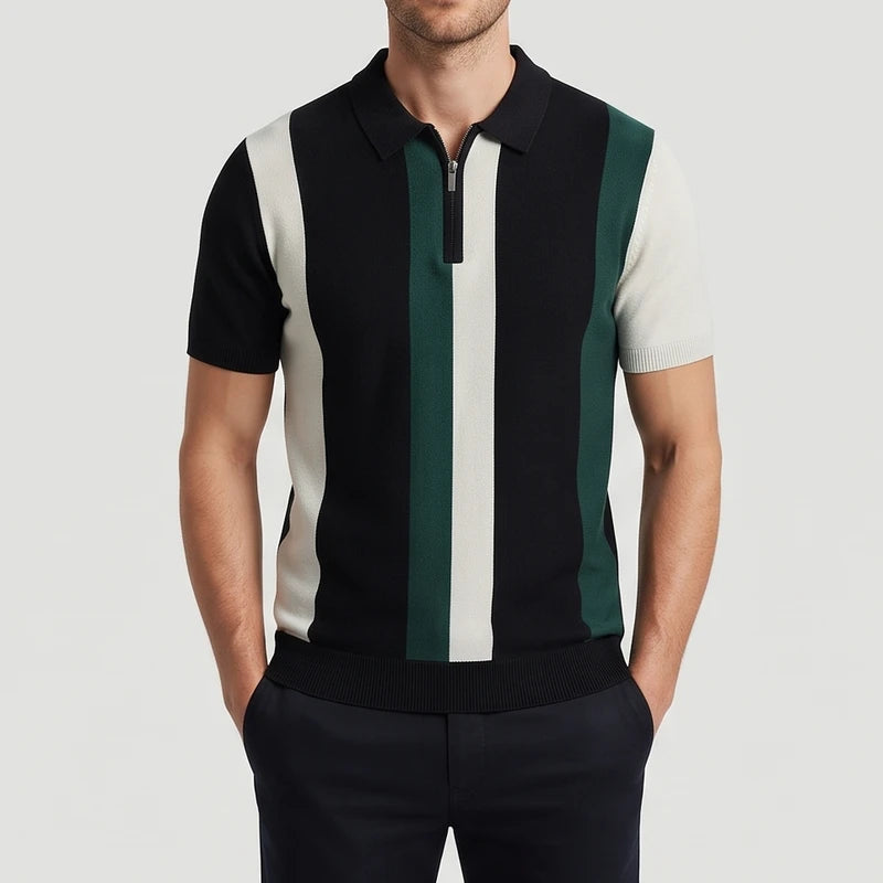 Man wearing a black, cream, and green striped quarter-zip knit polo shirt with short sleeves and ribbed hem.