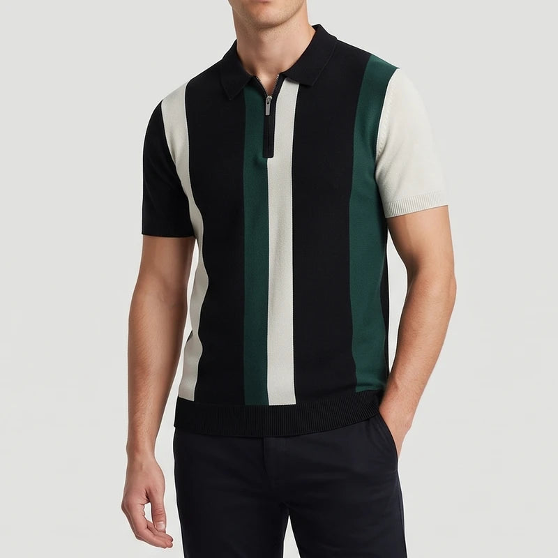 Man wearing a short-sleeved knitted polo shirt with black, cream, and green vertical stripes, featuring a silver quarter-zip.
