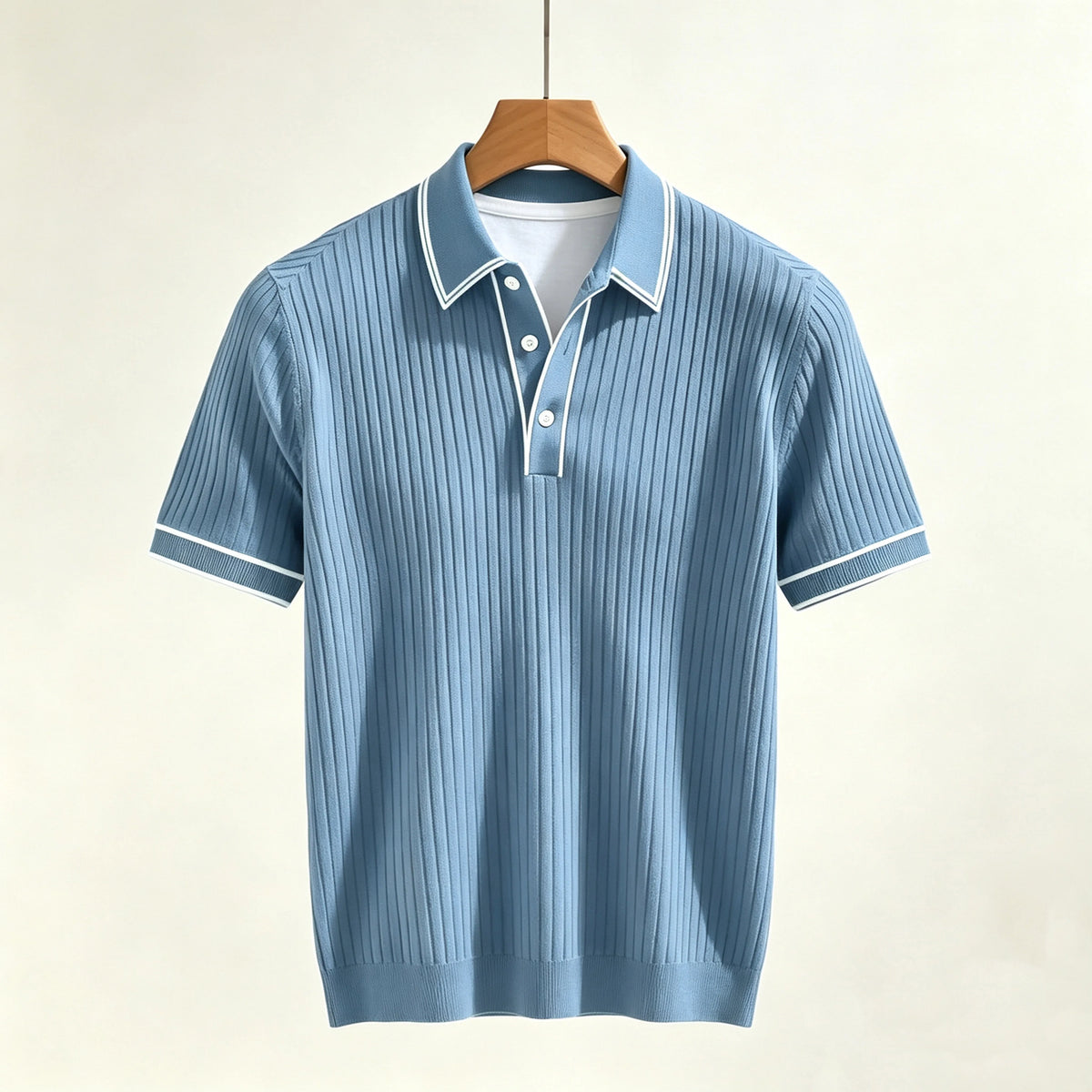 Light blue ribbed polo shirt with short sleeves, white collar, white trim, and three white buttons, hanging on a wooden hanger.