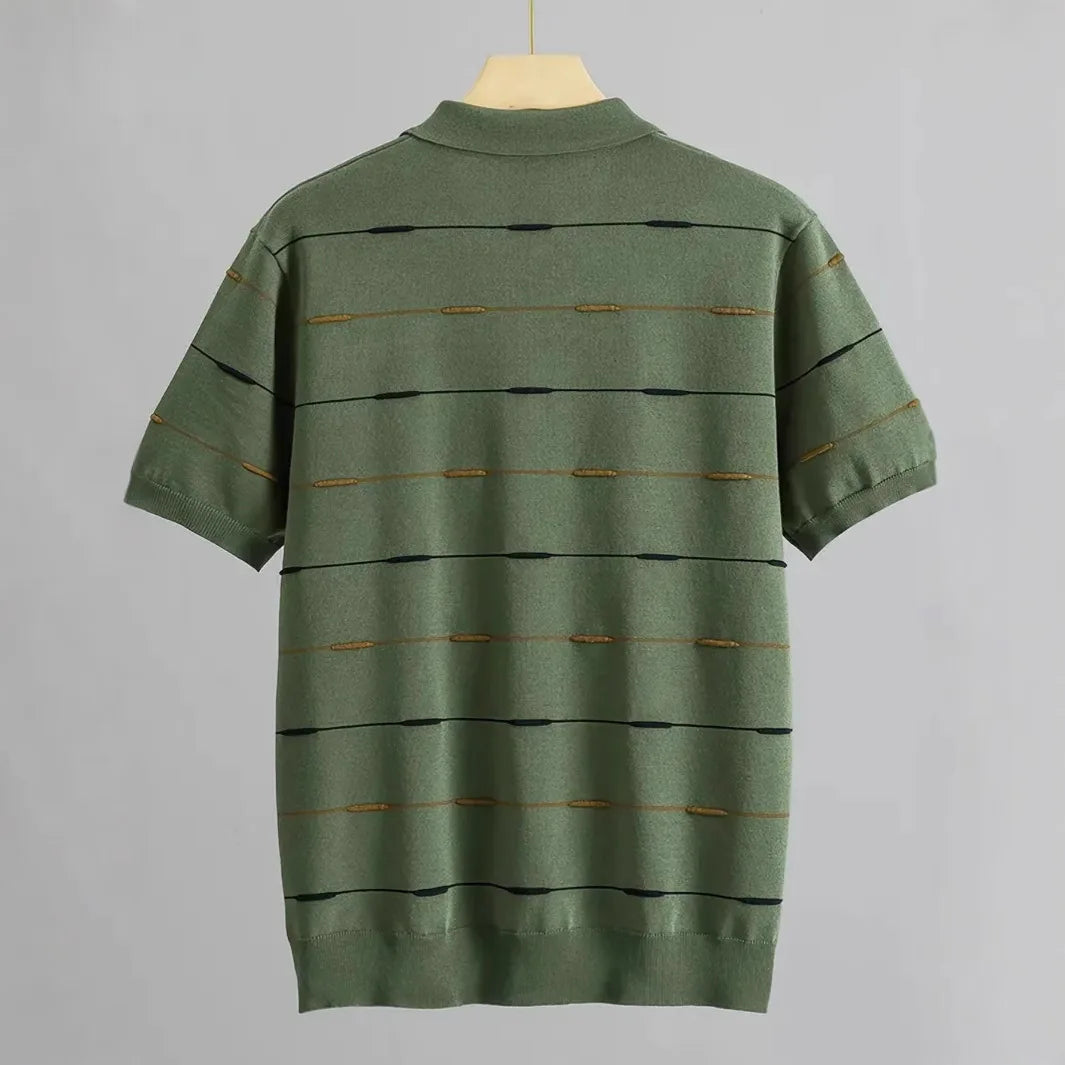 Back view of a green short-sleeved knit polo shirt with horizontal black and gold striped patterns.