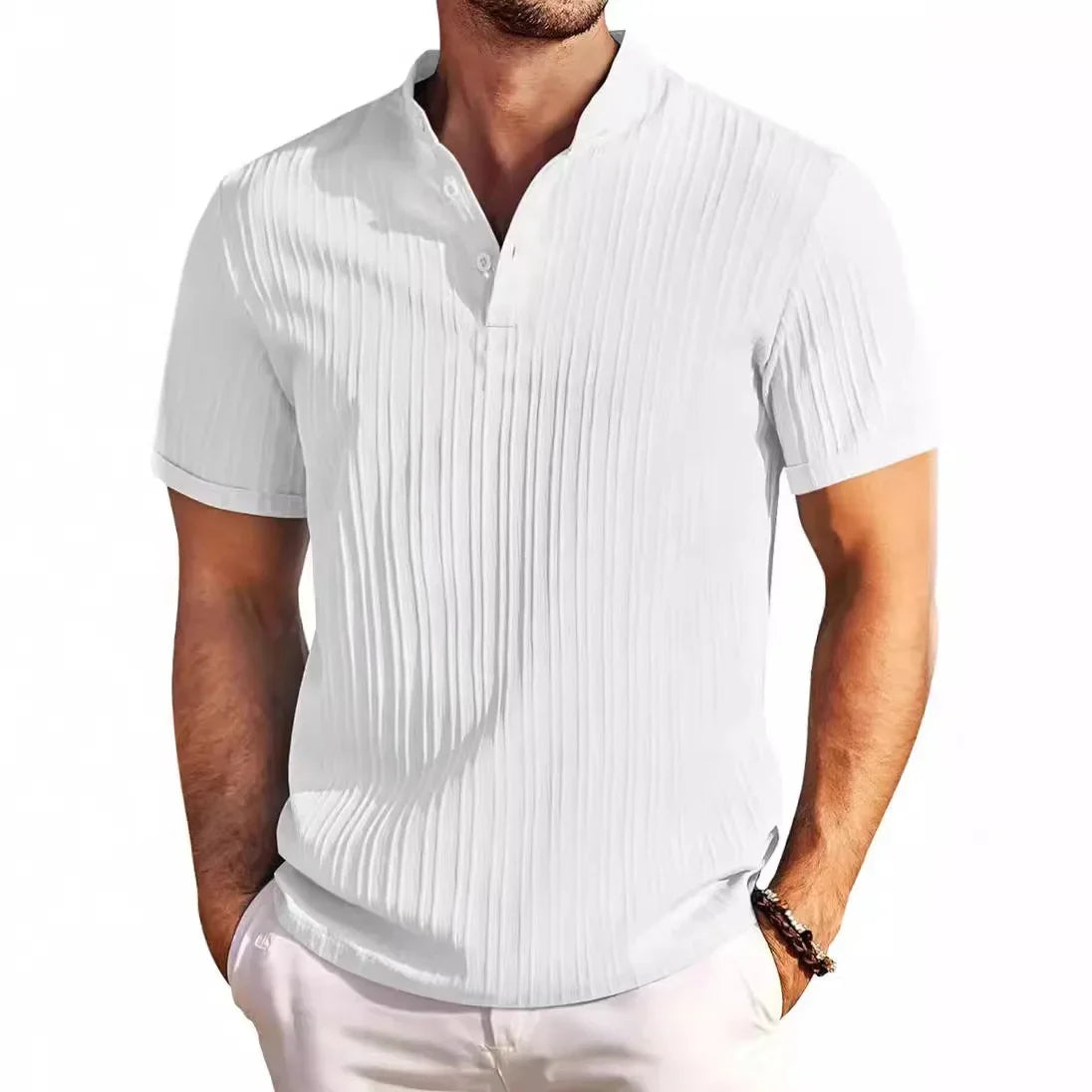 Man wearing a white short-sleeved collared shirt with vertical pleats and two visible buttons, hands in pockets.