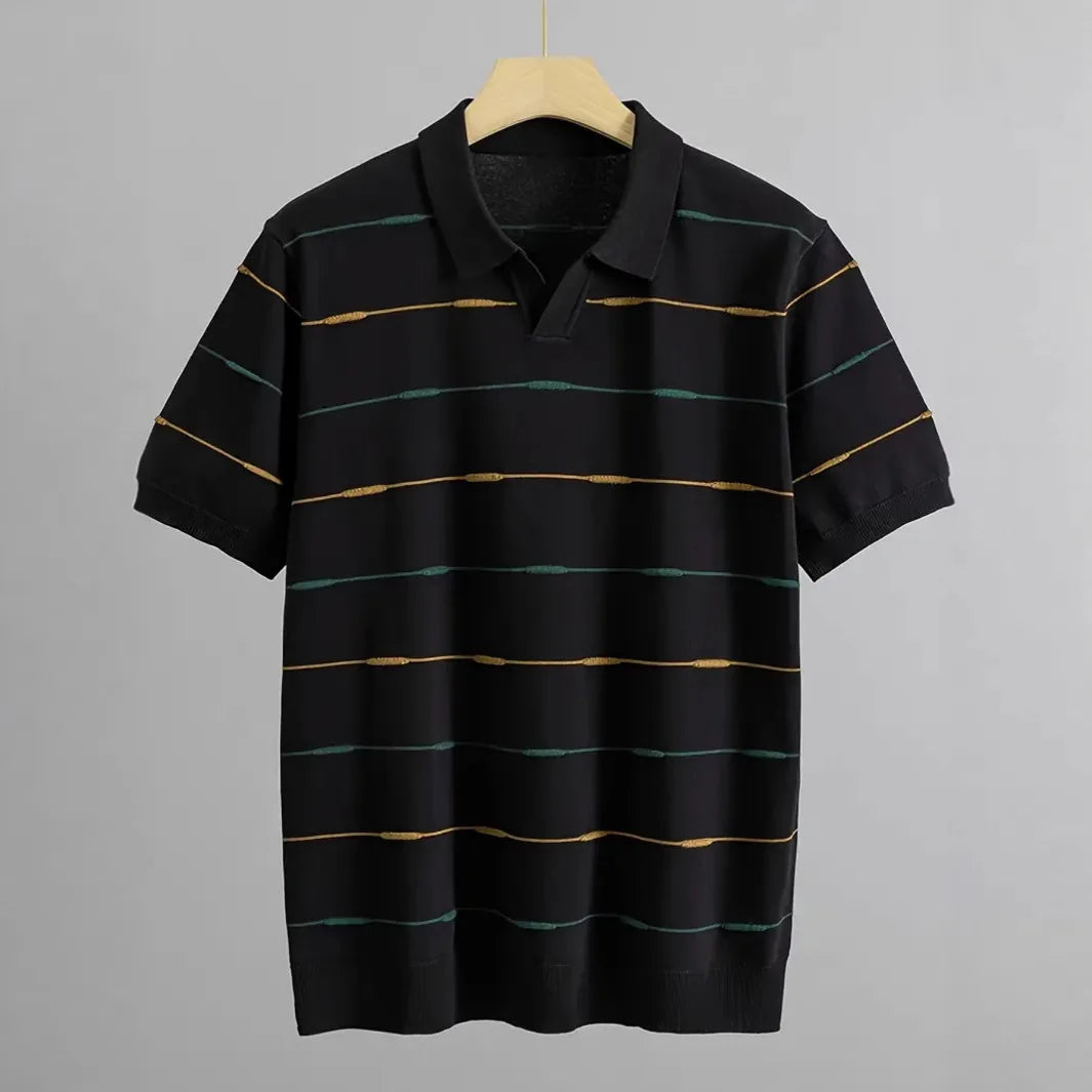 Black knit polo shirt with short sleeves, collar, and horizontal green and yellow textured stripes on a wooden hanger.