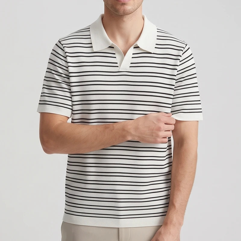 Man wearing a short-sleeve polo shirt with white and black horizontal stripes, light collar, and light tan pants.