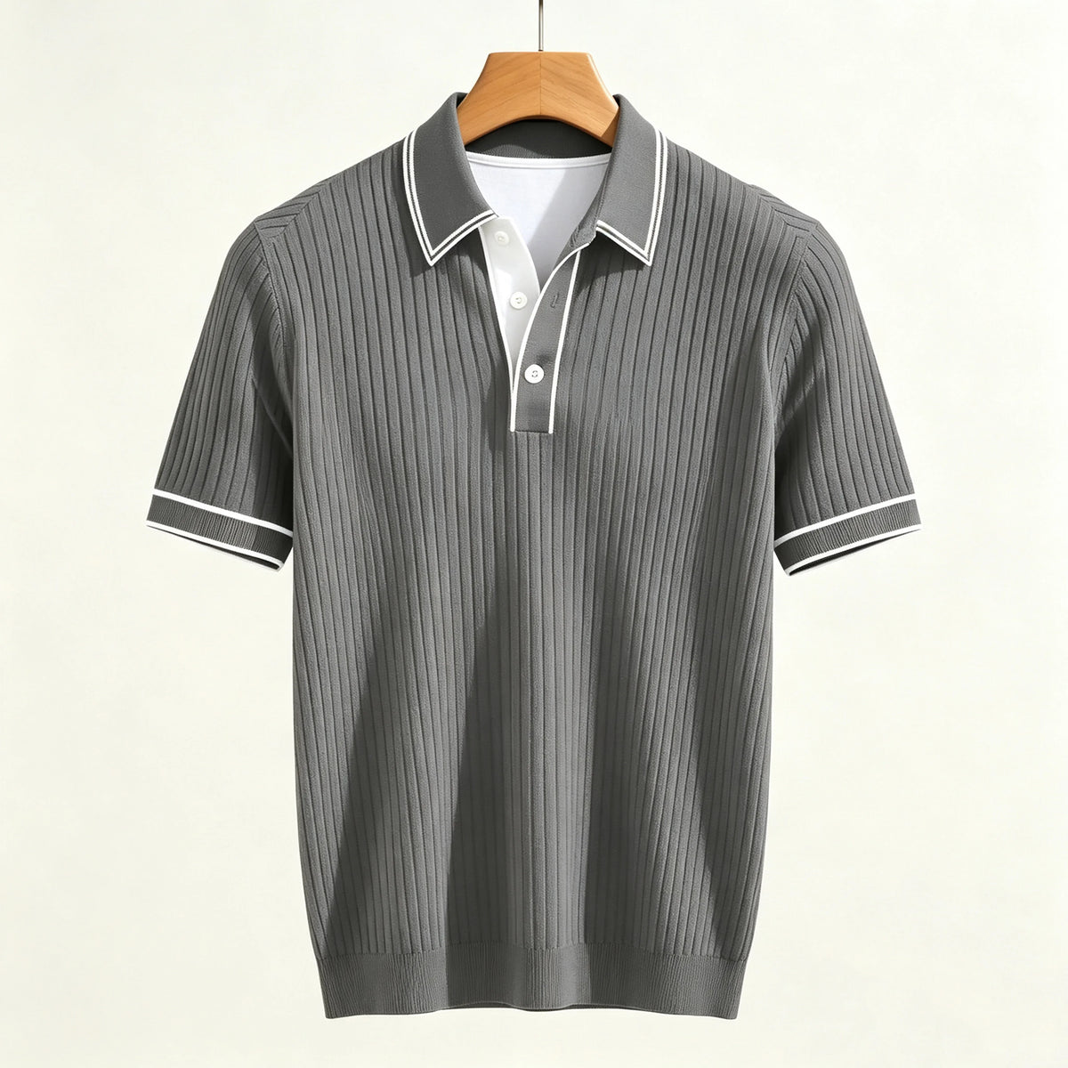 Gray ribbed knit short-sleeve polo shirt with a white collar, two white placket buttons, and white striped cuffs.