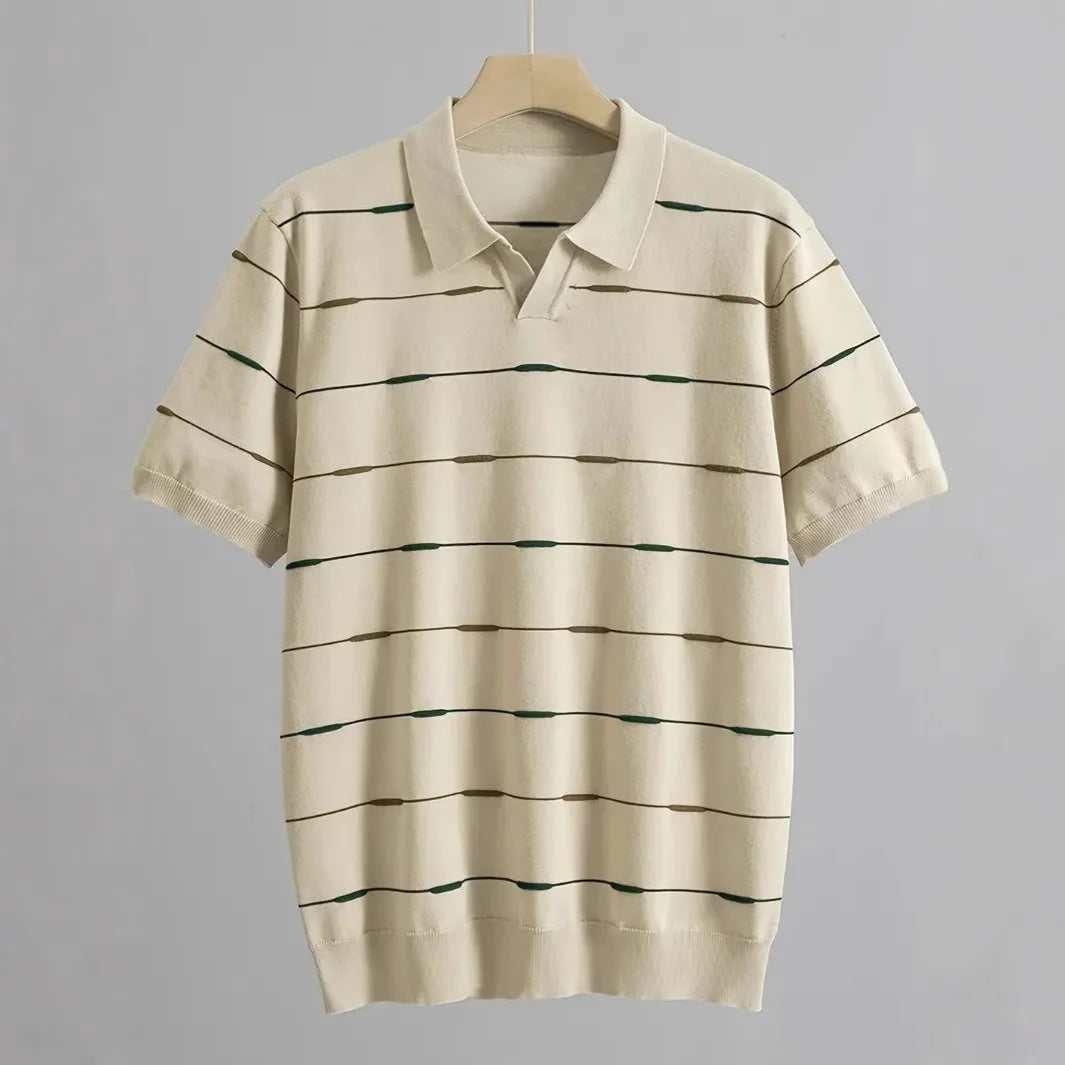Cream short-sleeved polo shirt with horizontal black, olive green, and brown dashed stripes, displayed on a hanger.
