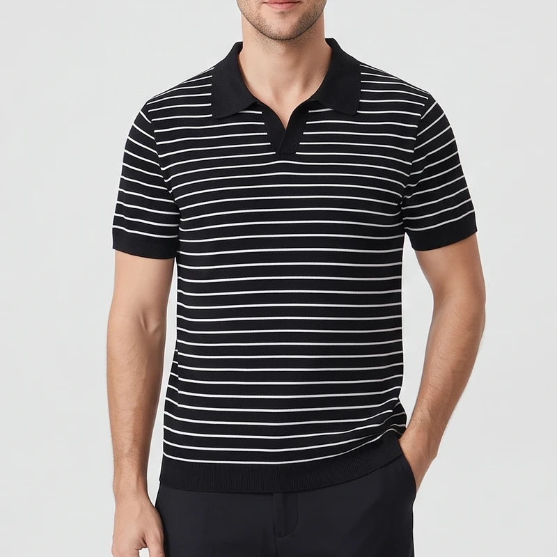 Man wearing a black short-sleeve polo shirt with thin white horizontal stripes and a black knit collar.