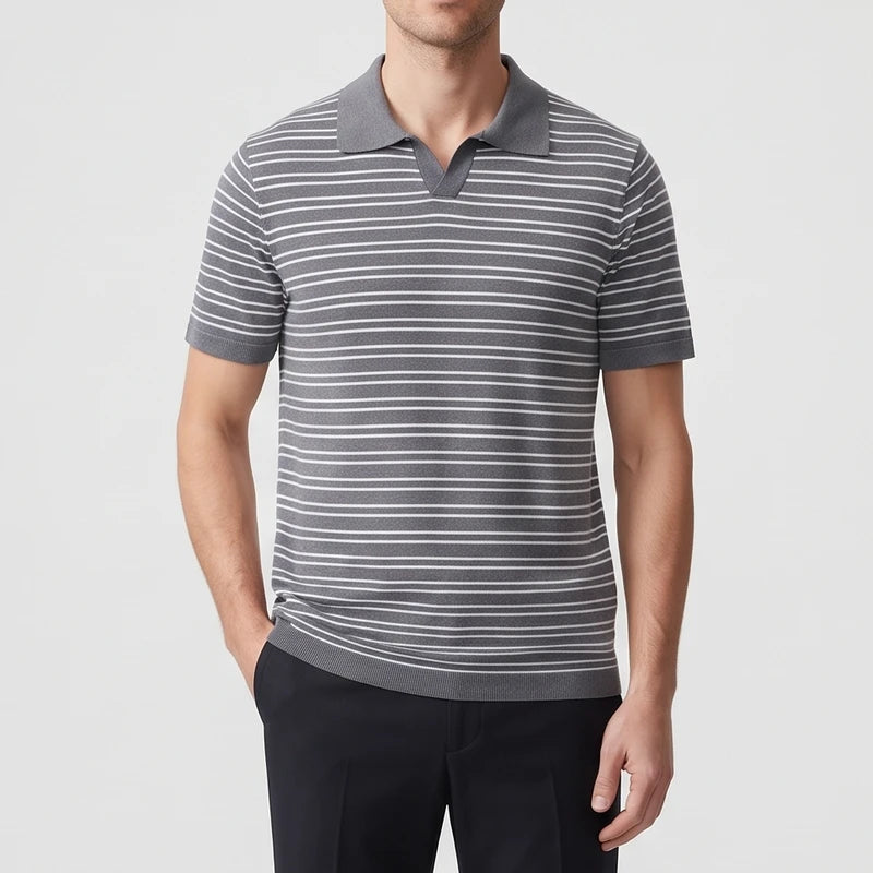 Man wearing a short-sleeve gray and white striped polo shirt with a V-neck collar, posing with hand in pocket.