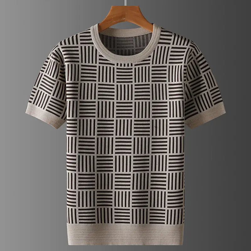 Short sleeve knit shirt in beige and dark brown geometric checkerboard pattern, with ribbed trim, hanging on a wooden hanger.