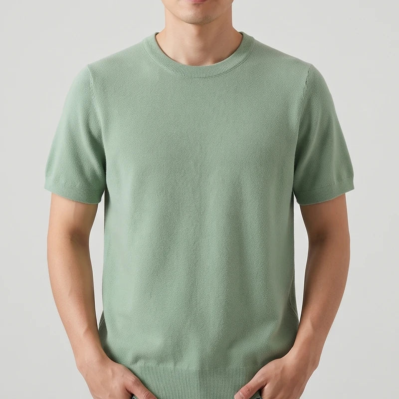 Green sweater on an off-gray studio background