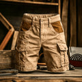 Tan cargo shorts with two large side pockets and darker brown accents on the front hip pockets.
