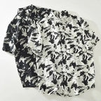 Two black and white patterned shirts on a white background