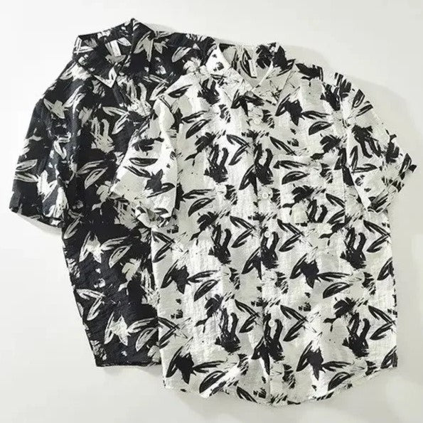 Two black and white patterned shirts on a white background