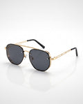 Black and gold-toned aviator sunglasses with decorative perforated side shields and black temple tips on a white background.