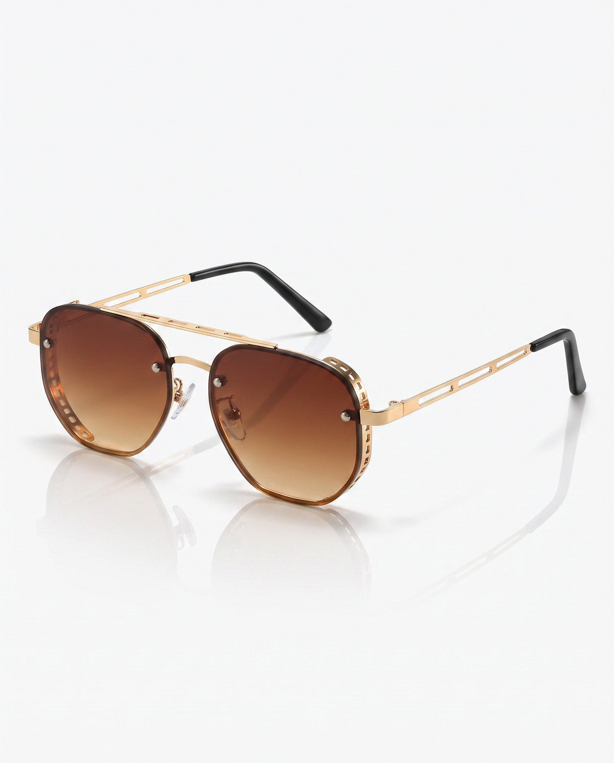 Gold-toned octagonal sunglasses with brown gradient lenses, a double bridge, and perforated side shields, on a white reflective surface.