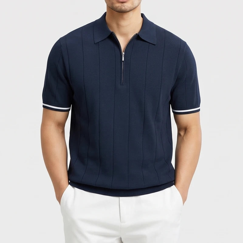 Navy knitted polo on an off-gray studio background