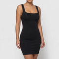 Black dress on an off-gray studio background